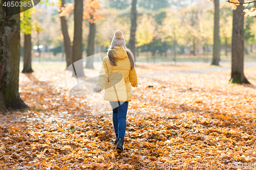 Image of happy girl running in autumn park