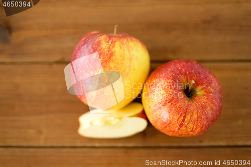 Image of ripe red apples on wooden table