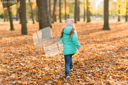 Image of happy girl running in autumn park