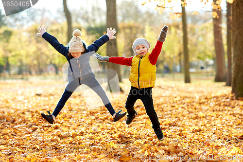 Image of happy children running at autumn park