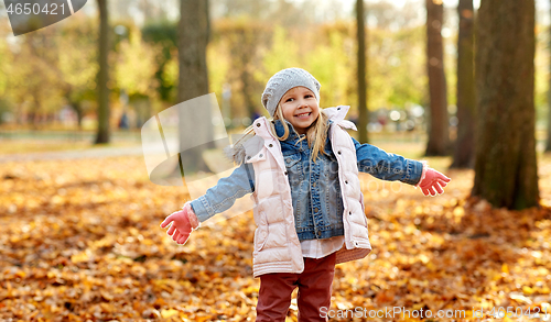 Image of happy little girl at autumn park