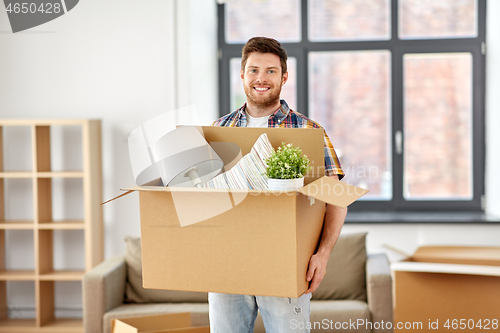 Image of happy man with box moving to new home