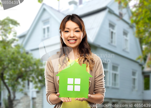 Image of happy asian woman with green house