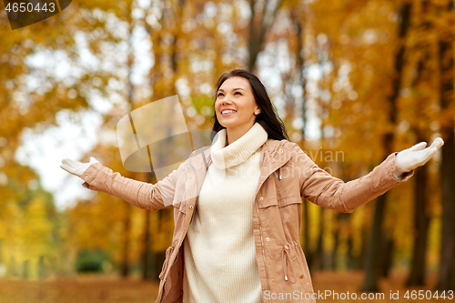 Image of beautiful happy young woman in autumn park