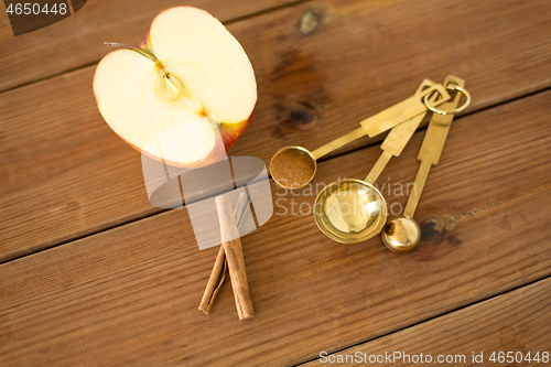 Image of half apple and knife on wooden cutting board