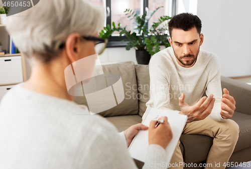 Image of senior woman psychologist and sad man patient