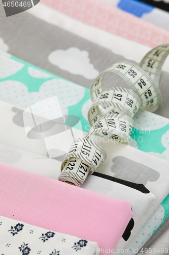 Image of cotton fabric material and tailor measurement tape