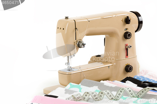 Image of Sewing machine, fabric and measurement tape