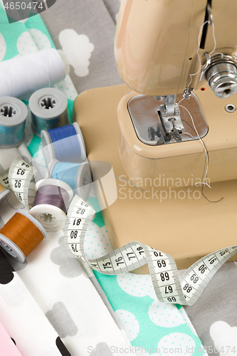 Image of Sewing machine, fabric and measurement tape