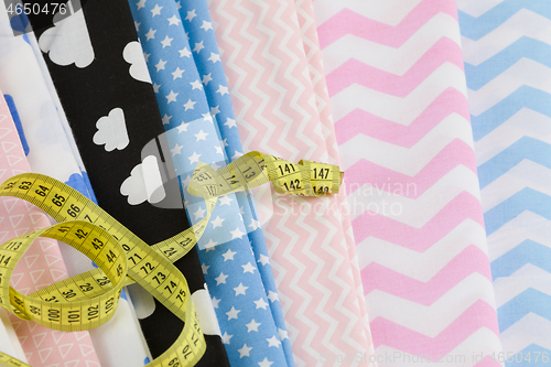 Image of cotton fabric material and tailor measurement tape