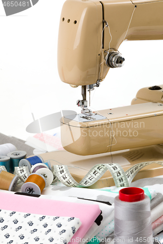 Image of Sewing machine, fabric and measurement tape