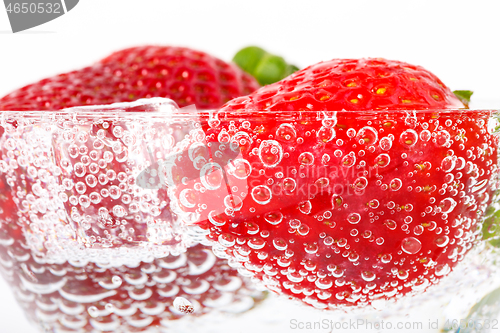 Image of fresh strawberry in glass with sparkling water