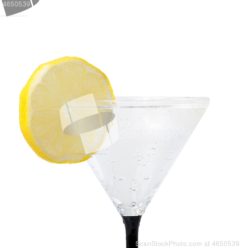 Image of fresh lemon in glass with water drops