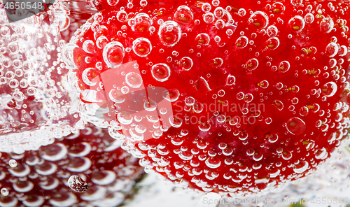 Image of fresh strawberry in glass with sparkling water