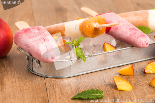 Image of Homemade raspberries and peach popsicles