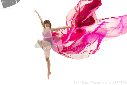 Image of Ballerina. Young graceful female ballet dancer dancing over white studio. Beauty of classic ballet.