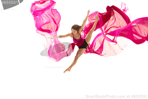 Image of Ballerina. Young graceful female ballet dancer dancing over white studio. Beauty of classic ballet.