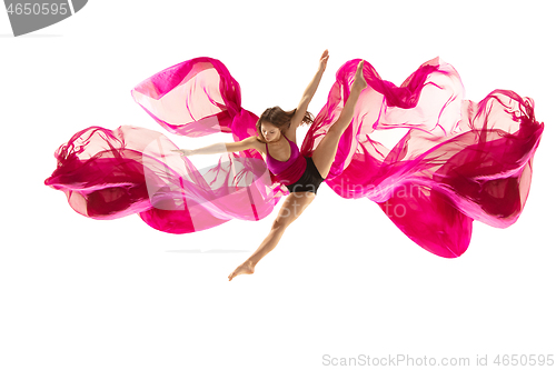 Image of Ballerina. Young graceful female ballet dancer dancing over white studio. Beauty of classic ballet.