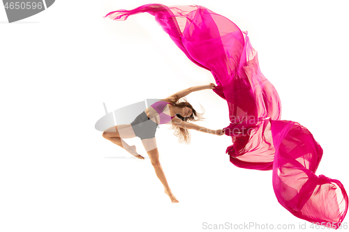 Image of Ballerina. Young graceful female ballet dancer dancing over white studio. Beauty of classic ballet.