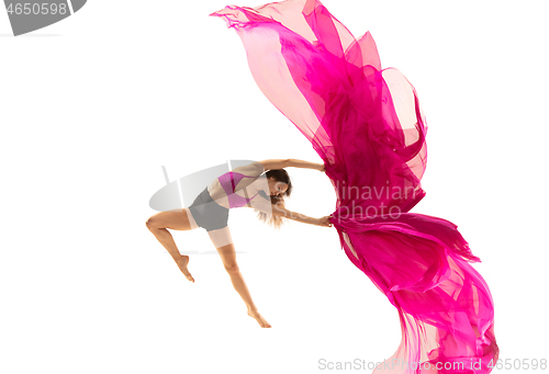 Image of Ballerina. Young graceful female ballet dancer dancing over white studio. Beauty of classic ballet.