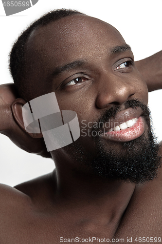 Image of Close up portrait of a young naked african man indoors