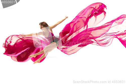 Image of Ballerina. Young graceful female ballet dancer dancing over white studio. Beauty of classic ballet.