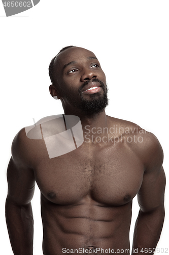 Image of Close up portrait of a young naked african man indoors