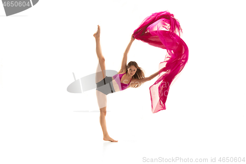 Image of Ballerina. Young graceful female ballet dancer dancing over white studio. Beauty of classic ballet.