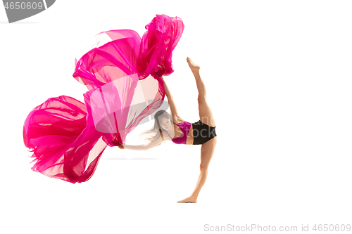 Image of Ballerina. Young graceful female ballet dancer dancing over white studio. Beauty of classic ballet.