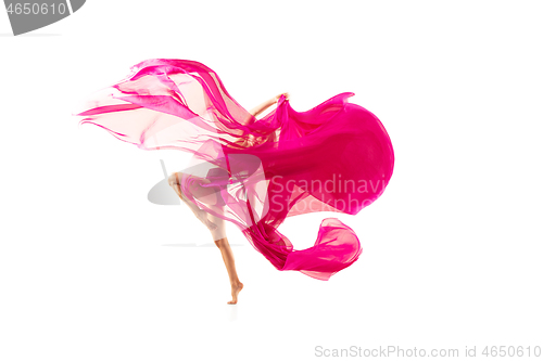 Image of Ballerina. Young graceful female ballet dancer dancing over white studio. Beauty of classic ballet.