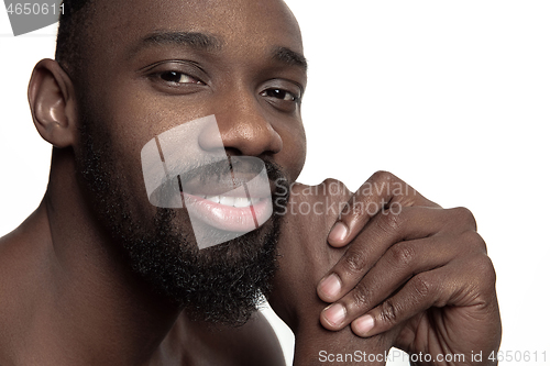 Image of Close up portrait of a young naked african man indoors