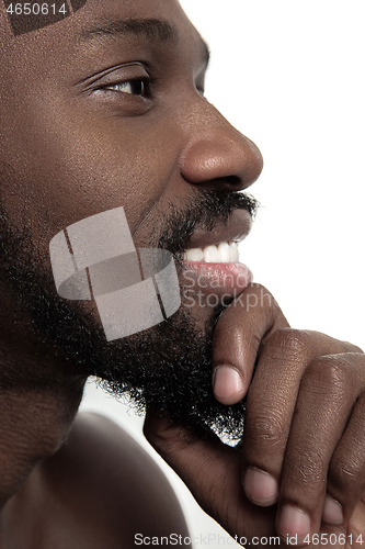 Image of Close up portrait of a young naked african man indoors