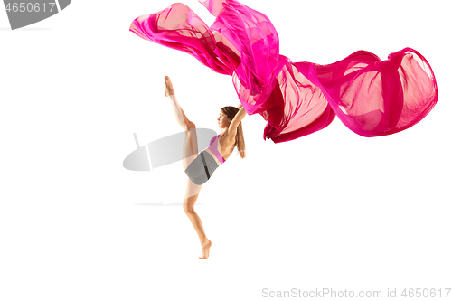 Image of Ballerina. Young graceful female ballet dancer dancing over white studio. Beauty of classic ballet.