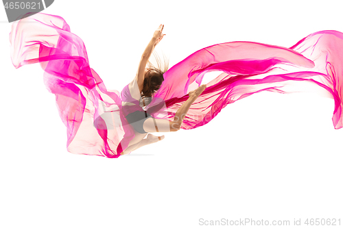 Image of Ballerina. Young graceful female ballet dancer dancing over white studio. Beauty of classic ballet.