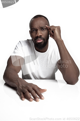 Image of Close up portrait of a young african man indoors