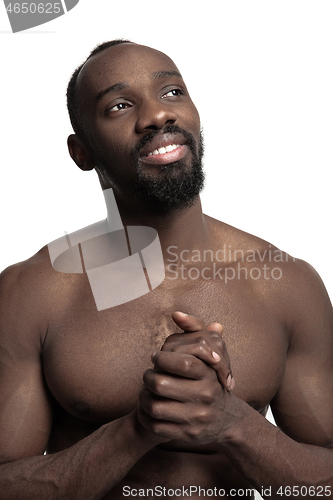 Image of Close up portrait of a young naked african man indoors