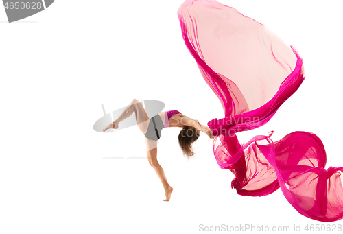 Image of Ballerina. Young graceful female ballet dancer dancing over white studio. Beauty of classic ballet.