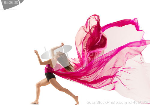 Image of Ballerina. Young graceful female ballet dancer dancing over white studio. Beauty of classic ballet.