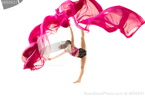 Image of Ballerina. Young graceful female ballet dancer dancing over white studio. Beauty of classic ballet.