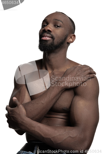 Image of Close up portrait of a young naked african man indoors