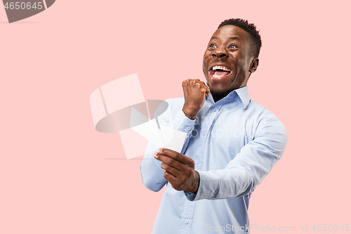 Image of Young boy with a surprised expression bet slip on blue background