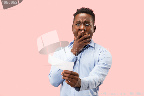 Image of Young boy with a surprised expression bet slip on pink background