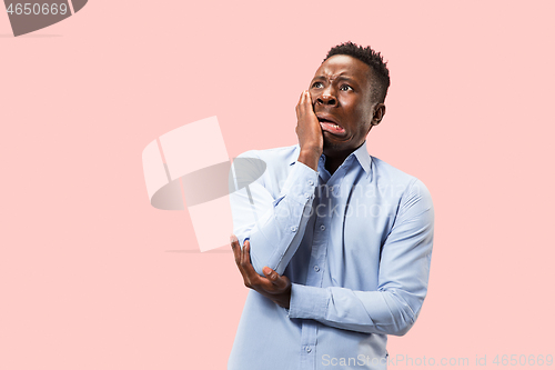 Image of Young boy with a surprised expression bet slip on pink background