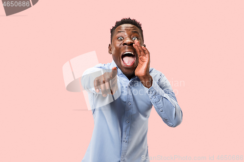 Image of Isolated on pink young casual man shouting at studio