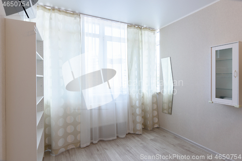 Image of Blind windows in the interior of an apartment room in a multi-storey building