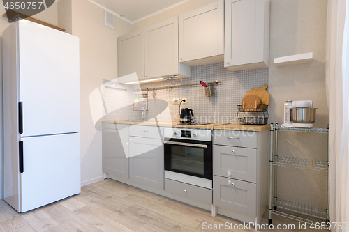 Image of Kitchen layout, fridge and direct kitchen with hanging cupboards