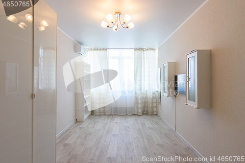 Image of Interior of a bedroom partially freed from furniture due to relocation