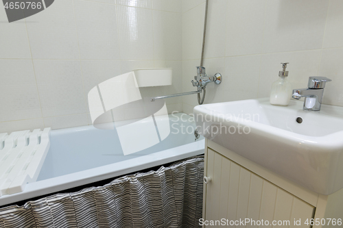 Image of Small budget bathroom with a small washbasin