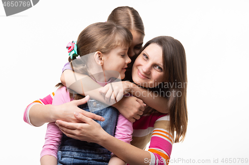 Image of Two sisters and mom are hugging happily, isolated on white background