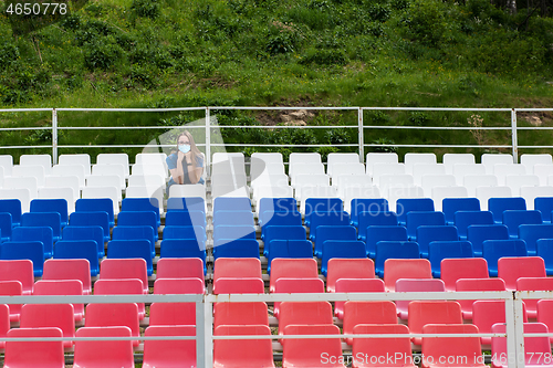 Image of Lonely woman on the empty stadium outdoor